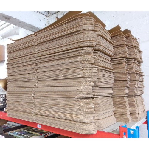 82 - A large bundle of cardboard boxes for packaging.