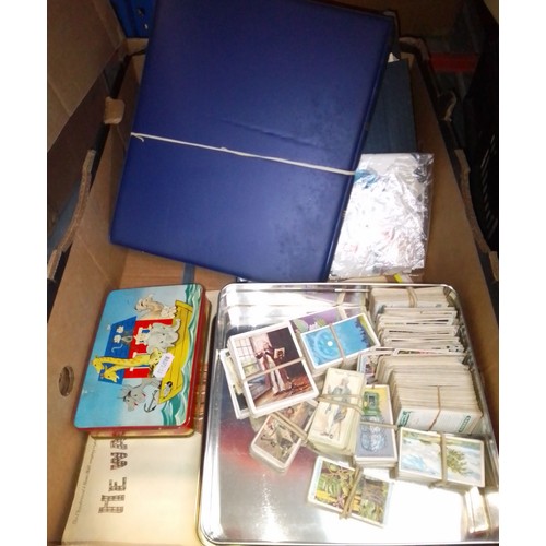 134 - A box including stamp albums, cigarette cards, music and postcards.