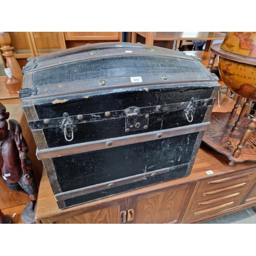 919 - A vintage dome top travel trunk.