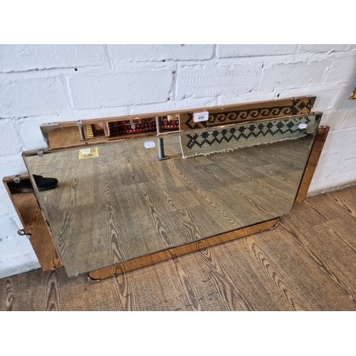 898 - A 1930s Art Deco wall mirror with peach glass panels, 90.5cm x 50cm.