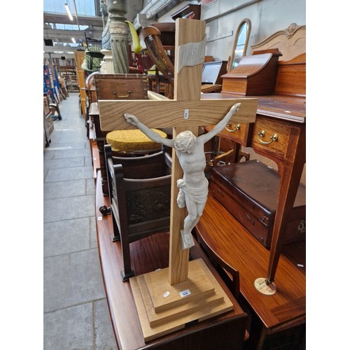 930 - A light oak and cast resin crucifix, height 91cm.