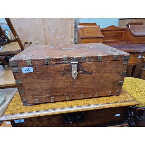 925 - An Indian teak and brass bound box with fitted interior.