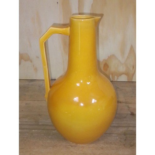 302 - A yellow pottery jug designed by Christopher Dresser for Lear Pottery, height 26cm.