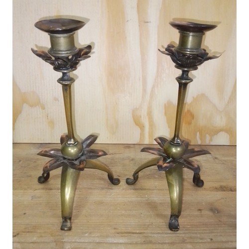 394 - A pair of Arts & Crafts copper and brass candlesticks in the manner of WAS Benson, height 23cm.