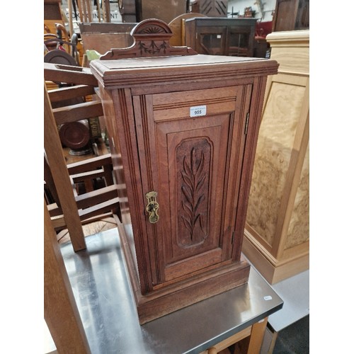 955 - An Edwardian walnut bedside cabinet.