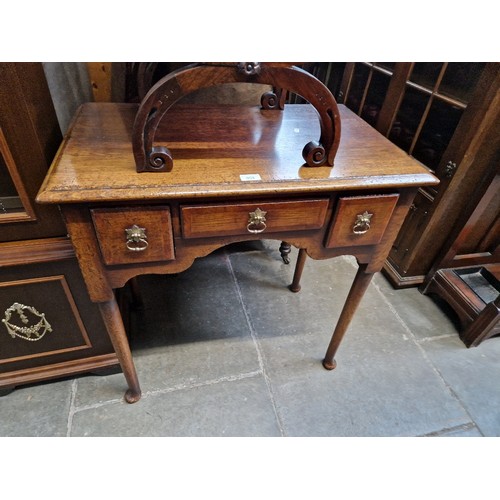 959 - An 18th century style oak lowboy, by Titchmarsh & Goodwin.