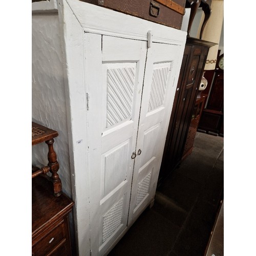 947 - A rustic white painted linen press.