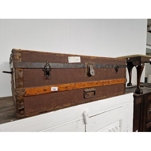 946 - A vintage travel trunk with various old travel labels.