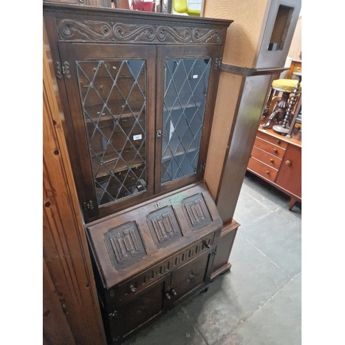 957 - A linen fold bureau bookcase.