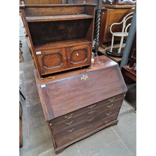 985 - A George III mahogany bureau and a small oak bookcase.