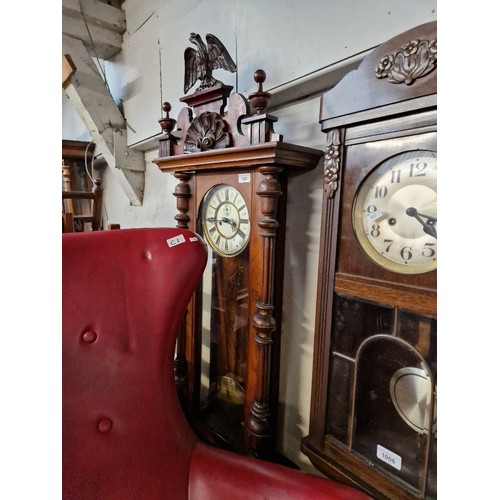 1007 - A walnut cased Vienna wall clock with pendulum and key.