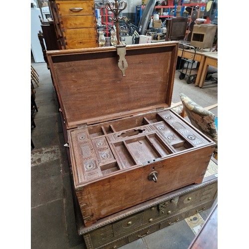 1015 - A 19th century teak chest with fitted interior.