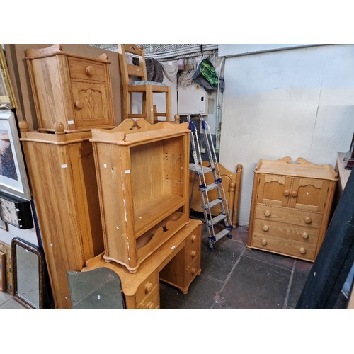 1011 - A suite of light wood bedroom furniture comprising wardrobe, dressing table, tallboy, bedside cabine... 