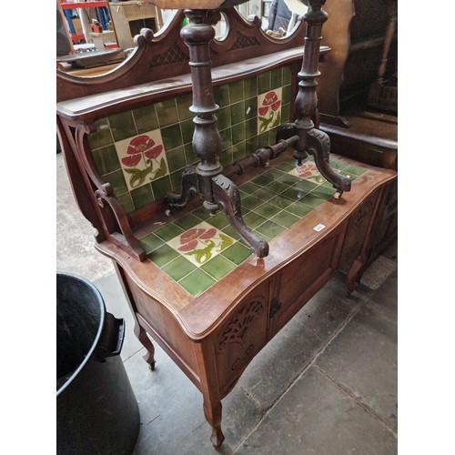 1021 - An Edwardian mahogany tile back washstand.