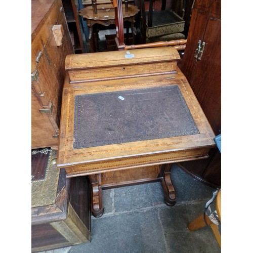 1023 - A Victorian inlaid walnut Davenport.