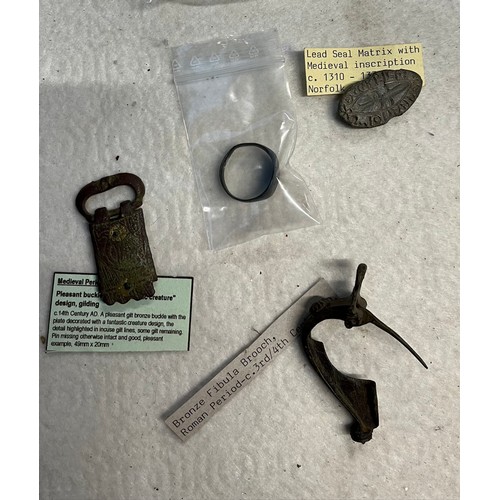 522 - Assorted metal detector finds comprising a Roman bronze fibular brooch, a medieval gilt bronze buckl... 