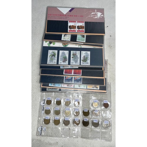 531 - A collection of Chinese stamp presentation packs and Hong Kong coins.