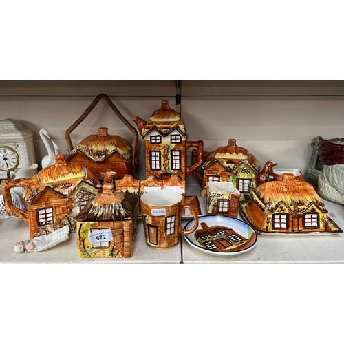 672 - 14 pieces of cottage ware including coffee pot, 2 teapots, biscuit barrel, etc.