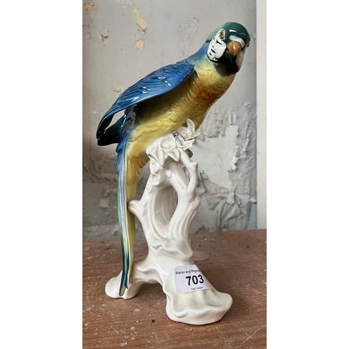 703 - A ceramic figure by Karl Ens, modelled as a parrot on a branch,