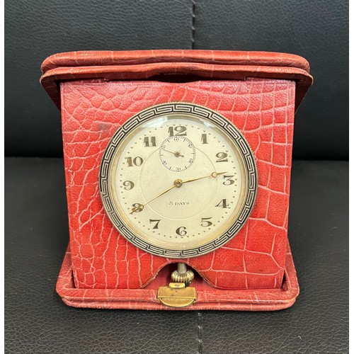 498 - A red leather cased 8 day travelling clock