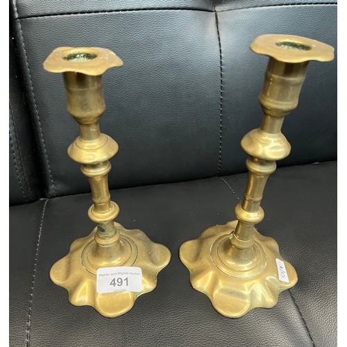 491 - A pair of early 18th century brass 'petal base' candlesticks