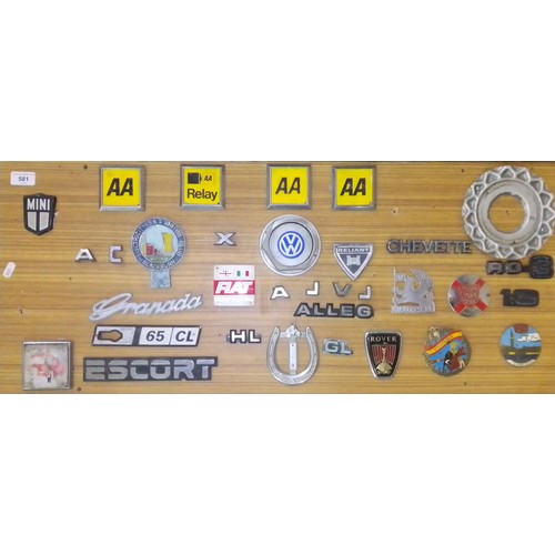 414 - A display board of various vehicles badges.