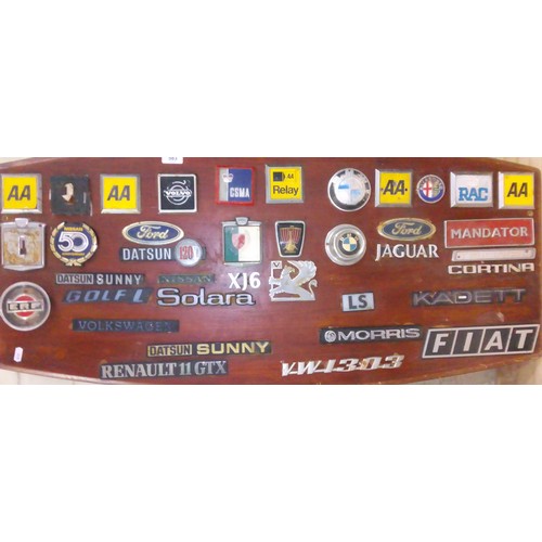 416 - A display board of various vehicles badges.