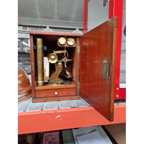 252 - A mahogany cased brass microscope, by Armstrong, Manchester, with 50 slides.