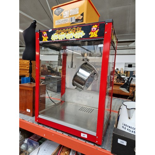 251 - A commercial popcorn machine with a number of popcorn boxes/bags.