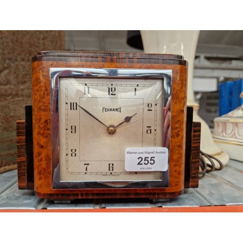 255 - An Art Deco burr walnut and rosewood Ferranti electric mantel clock.