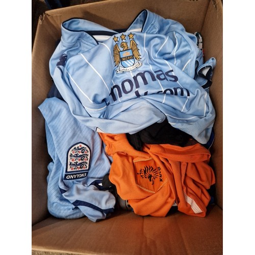 267 - A box of mixed football shirts, shorts, scarves and a Man United fleece.