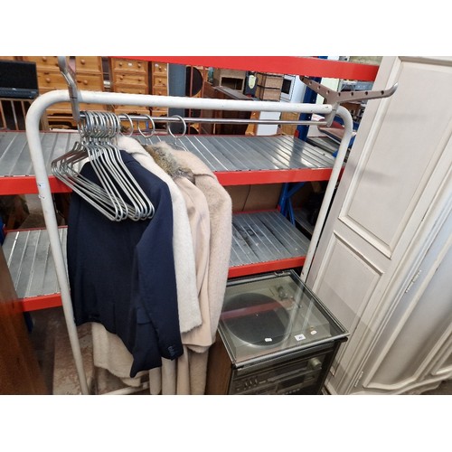 379 - A vintage mid 20th century clothes rail by R W Bamforth, with associated hangers and 3 coats and sui... 