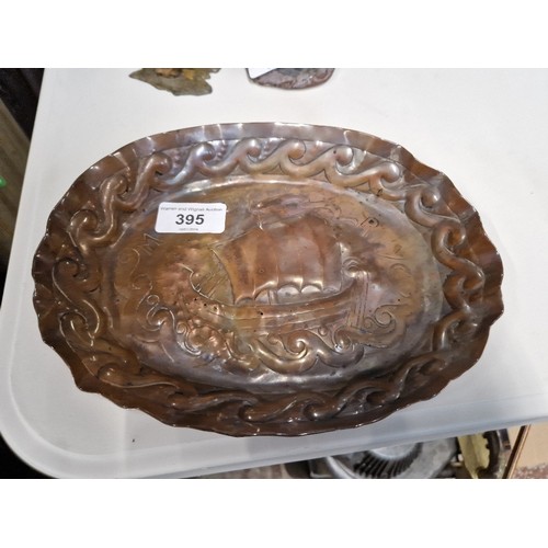 395 - An Arts & Crafts embossed copper dish decorated with a ship 'Moretta RTYC' (Royal Thames Yacht Club'... 