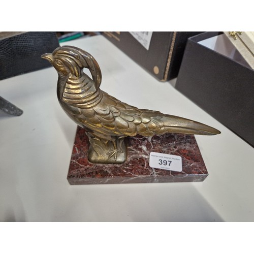 397 - An Art Deco bronzed bird and marble paperweight, length 18cm.