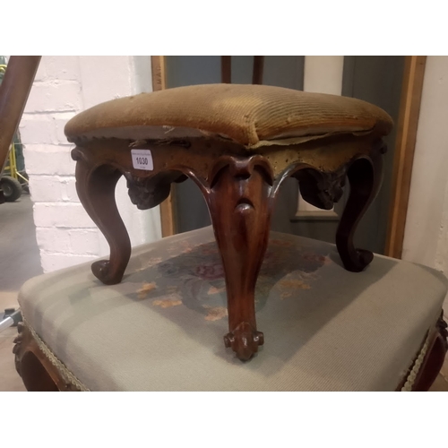 1030 - A Victorian walnut footstool.