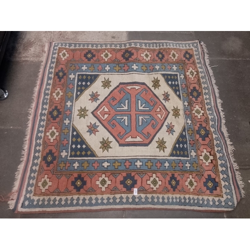 1041 - A vintage Eastern hand knotted wool carpet, 130cm x 132cm.