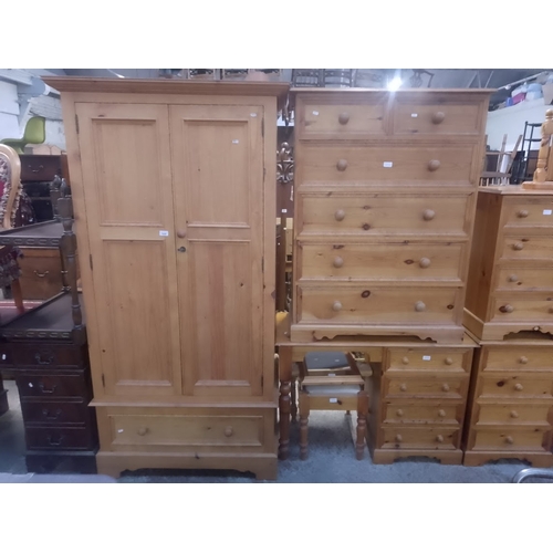 1046 - A pine double wardrobe, pine chest of drawers and a pine dressing table with mirror and stool.