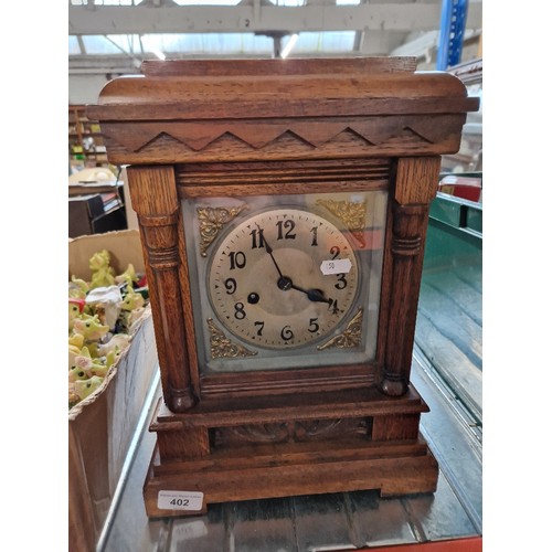 402 - An oak cased bracket clock, with keys & pendulum.