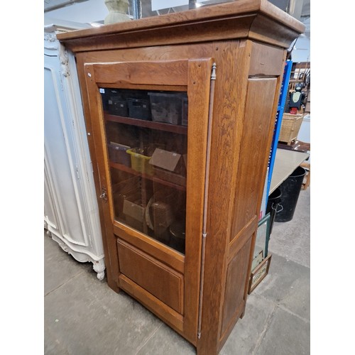 1059 - A French aged oak display cabinet.