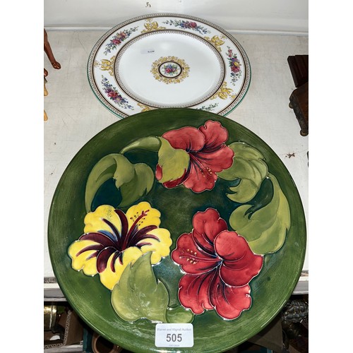 505 - A Moorcroft Hibiscus pattern platter, circular, diameter 31cm, together with a Wedgwood plate