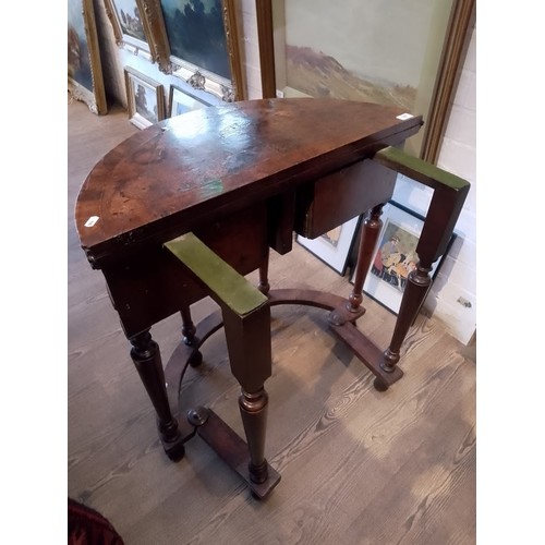 944 - A walnut demi-lune card table or credence table, circa 1700, with fold over top, three frieze drawer... 