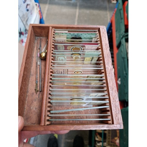 252 - A mahogany cased brass microscope, by Armstrong, Manchester, with 50 slides.