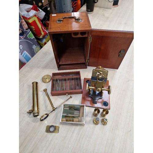 252 - A mahogany cased brass microscope, by Armstrong, Manchester, with 50 slides.