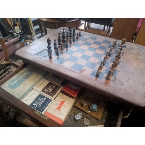 1022 - A Victorian walnut chess table with pieces.