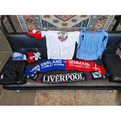 267 - A box of mixed football shirts, shorts, scarves and a Man United fleece.