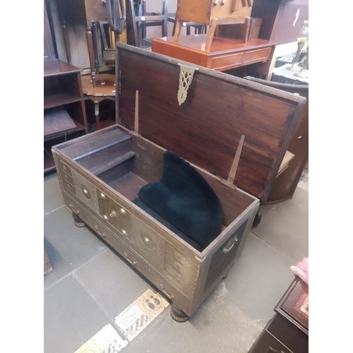 1016 - An Indian hardwood and brass studded chest.