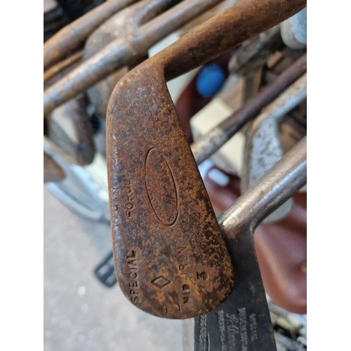 194 - A quantity of antique/vintage golf clubs.