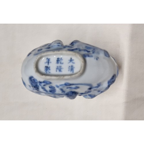 523 - A Chinese porcelain snuff bottle, embossed with foh dogs, tiger's eye top, Guangxu six character mar... 