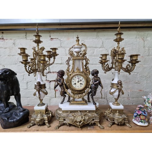 278 - A reproduction clock garniture, tallest measurement 69cm.