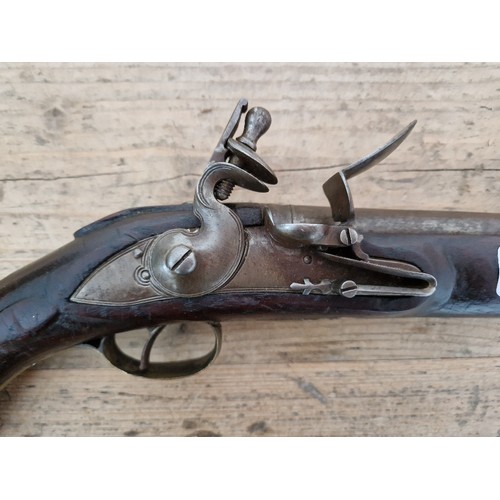 116 - A pair of reproduction flintlock pistols, 31cm barrel with ramrod below, touch hole is just an inden... 